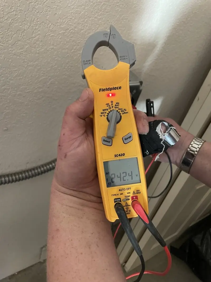 Voltage testing with clamp meter during Outlet Installation in Combee Settlement